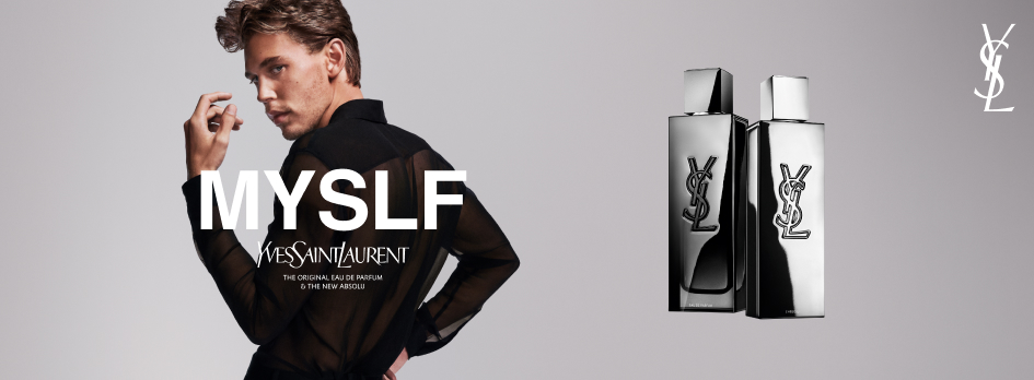 Werbung für das Parfum 'MYSLF' von Yves Saint Laurent. Links posiert ein Mann in einem transparenten schwarzen Oberteil mit sinnlichem Blick über die Schulter. Daneben der Schriftzug: 'MYSLF – Yves Saint Laurent – The original Eau de Parfum & the new Absolu'. Rechts im Bild stehen zwei elegante, silberglänzende Parfumflakons mit dem YSL-Logo. Der Hintergrund ist hellgrau und minimalistisch.
